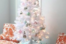 a small white Christmas tree decorated with pink and mint ornaments and lights is amazing for any pastel space