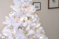 a white Christmas tree decorated with gold, pink and silver ornaments and lights is a very cool and chic idea
