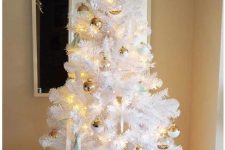 a white Christmas tree decorated with gold, white and mint ornaments and lights looks very fresh and cool