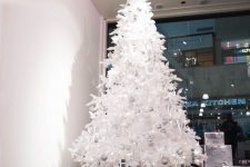 a white Christmas tree decorated with only silver ornaments looks ethereal, fresh and beautiful