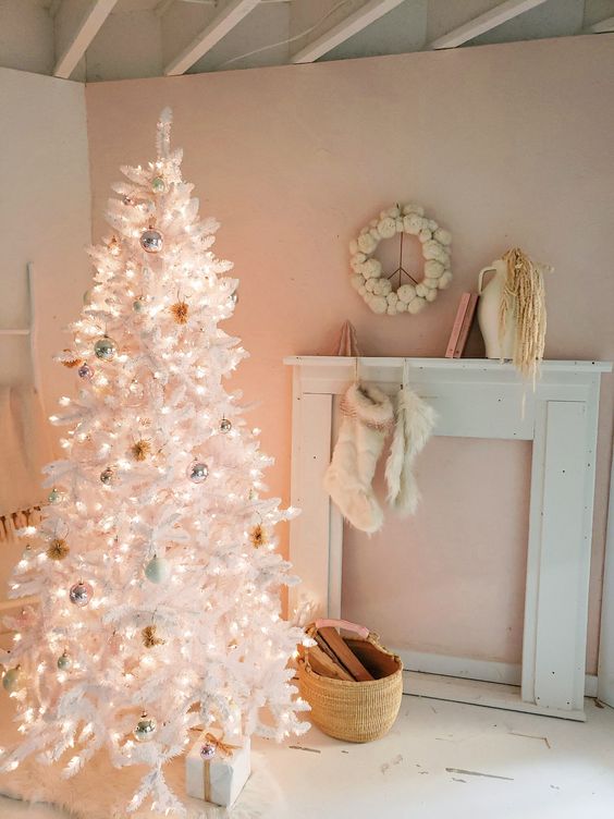 a white Christmas tree decorated with pastel and silver ornaments and lights looks very delicate, subtle and chic