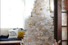 a white Christmas tree styled with gold baubles and himmeli ornaments looks cool, bright and elegant