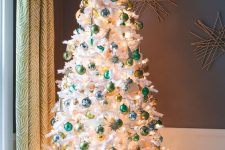 a white Christmas tree styled with green and light green ornaments and lights looks bold and contrasting