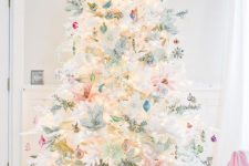 a white Christmas tree with vintage pastel ornaments, greenery and branches plus lights is amazing
