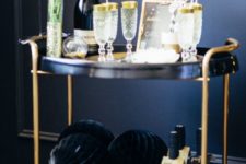 02 a black and gold cart with gold rim glasses and large pipe balls for an elegant feel