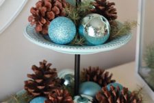 03 a blue porcelain cupcake stand with silver and turquoise ornaments, evergreens and pinecones