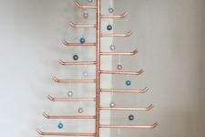 03 a copper pipe Christmas tree with various colorful ornaments
