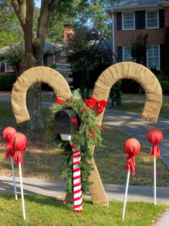 oversized candy canes wrapped with burlap is a cute idea