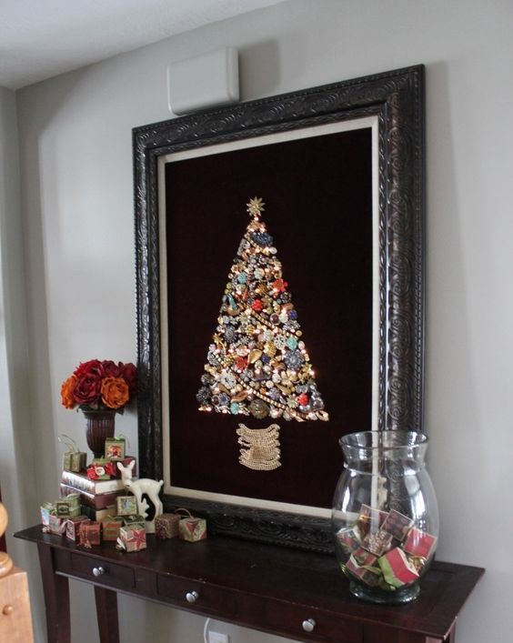 a large jewelry Christmas tree sign on black velvet in a vintage frame