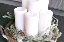 08 a wooden tray with evergreens, pinecones and candles is a simple and cozy display to make