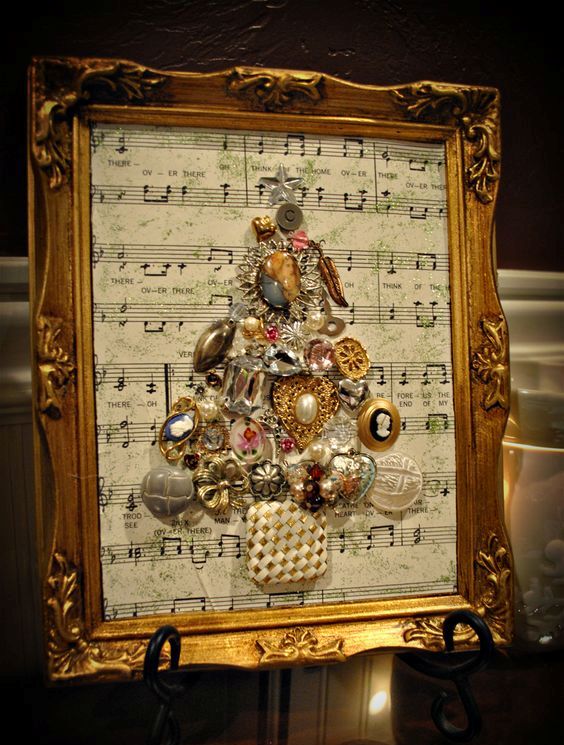 attach jewelry to form a tree to a music sheet with some Christmas carols