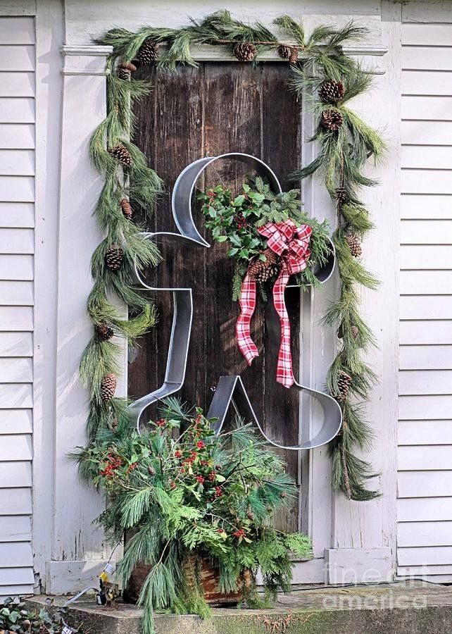 an oversized gingerbread cookie cutter decoration with evergreen garlands is a statement