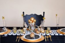 10 a gold charger, cutlery and ornaments blended with black and white plates and table runners