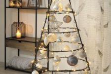 10 a metal Christmas tree with large ornaments and lots of LEDs
