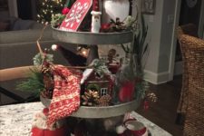 10 a metal cupcake stand with pinecones, berries, stockings, candy canes and gingerbread houses for a vintage feel