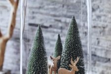 11 a cloche with pipe cleaner trees, wood and deer figurines for a cozy look