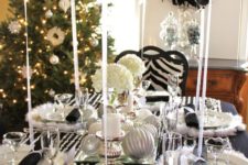 12 a black and silver tablescape with napkins, balloons, ornaments and some faux fur and crystals