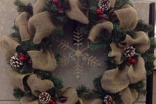 12 a rustic wreath of evergreens and burlap, snowy pinecones, berries and a gold snowflake