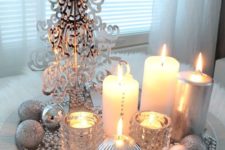 12 a silver tray with beads, a plastic tree, candles and silver ornaments for a glam space