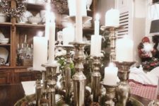13 a tray with pinecones, evergreens, silver ornaments and silve candle holders