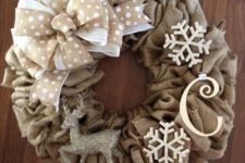 14 a burlap wreath with a ribbon bow, snowflakes, a monogram and a silver deer