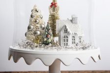 14 a cloche with a bead and ornament tree, tinsel trees and a white house for a vintage look