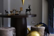 14 oversized gold ornament balloons over the table and around for a modern holiday feel