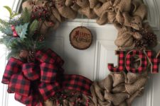 15 a burlap wreath with a plaid bow and letters, berries and faux greenery