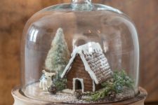 15 a cloche with a gingerbread house, a tinsel tree and little figurines will be a cool winter decoration