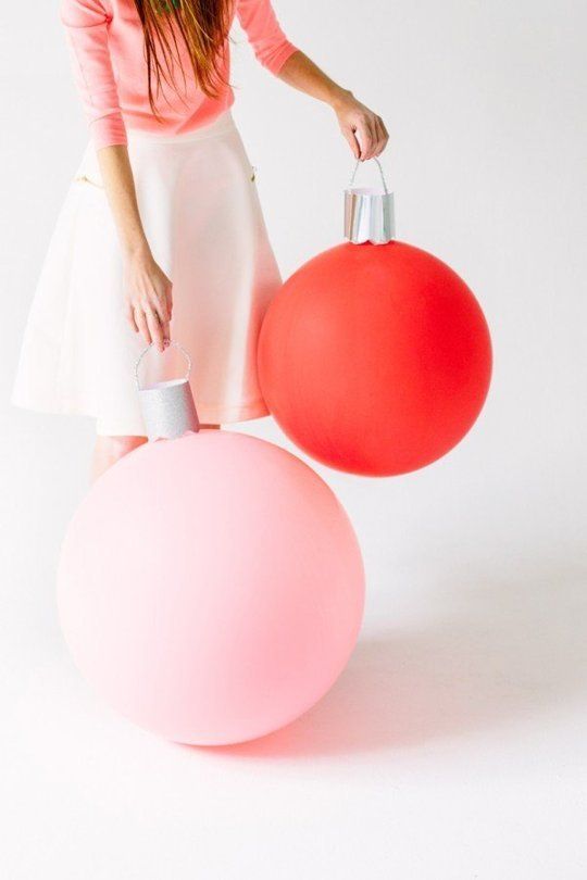 oversized holiday ornaments made of balloons and paper are a great idea