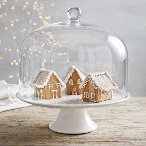 a cloche with gingerbread houses is a chic idea and can be eaten any time