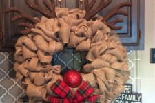 16 a fun burlap wreath with a red nose, a plaid bow and antlers to portray Rudolph