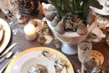 18 gold and silver touches – bells, ornaments, cutlery and white blooms in the planter for a chic tablescape