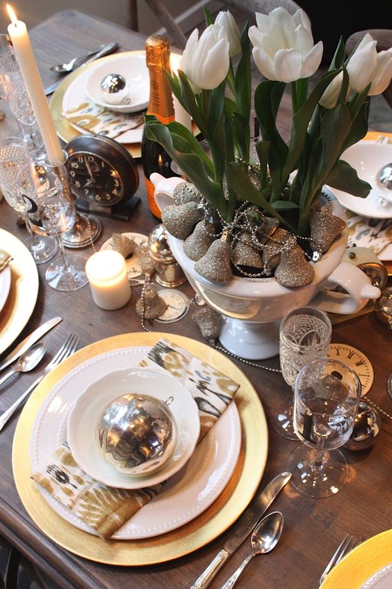 gold and silver touches   bells, ornaments, cutlery and white blooms in the planter for a chic tablescape