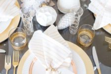 23 a grey and gold table setting with cone Christmas trees, geometric ornaments, gilded cutlery and glasses