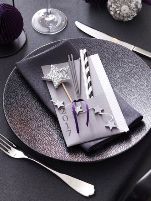 a textural charger, silver cutlery, litter glitter stars and ornaments in silver and purple