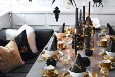 a stylish black and gold table setting