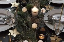 a homey NYE tablescape with evergreens, a lights garland, candles, gold stars