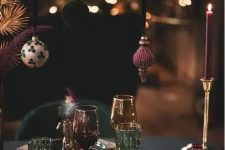 christmas ornaments hanging over a holiday table setting