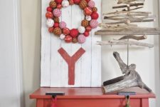 DIY pallet JOY sign with an ornament wreath