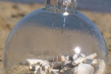DIY clear glass ornament filled with sand and shells
