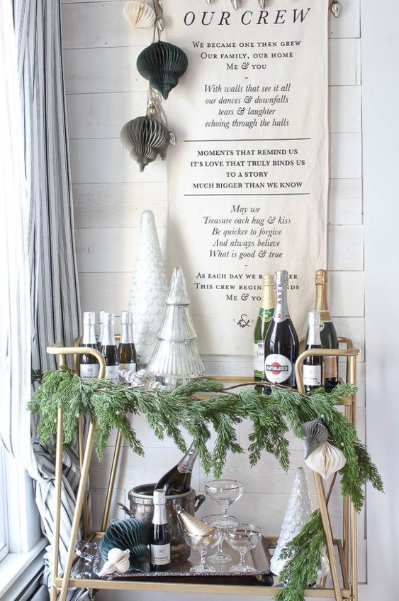 simple NYE bar cart styling with evergreens, mercury glass trees and some paper ornaments over the cart