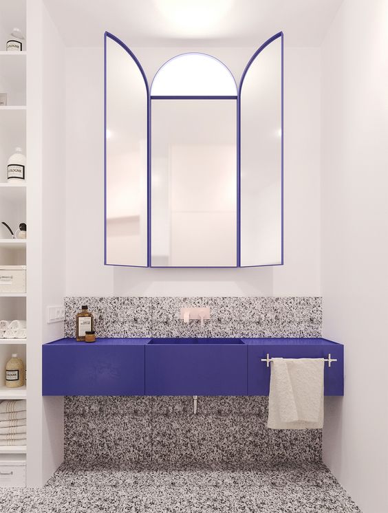 grey, black and white terrazzo on the floor and partly on the wall plus an ultra-violet vanity