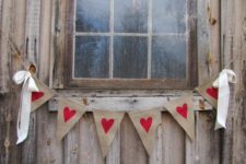 a banner with burlap hearts and ribbon bows will bring a rustic feel