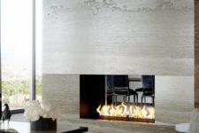 08 a luxurious double-sided fireplace becomes a focal point both in the living room and dining room