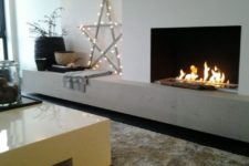 09 a built-in ethanol fireplace with a stone shelf that may be used as a seat