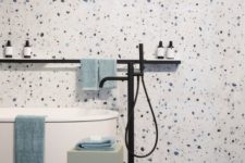 white, blue and purple terrazzo plus a free-standing bathtub and some clean lines