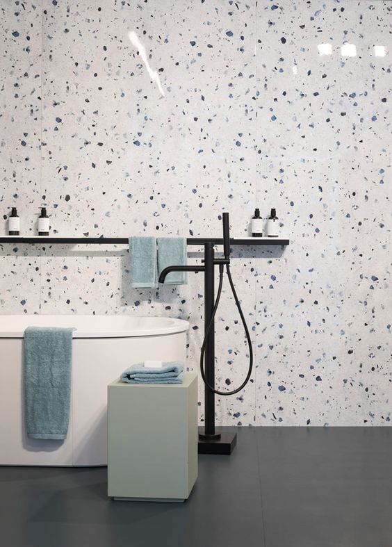 white, blue and purple terrazzo plus a free standing bathtub and some clean lines