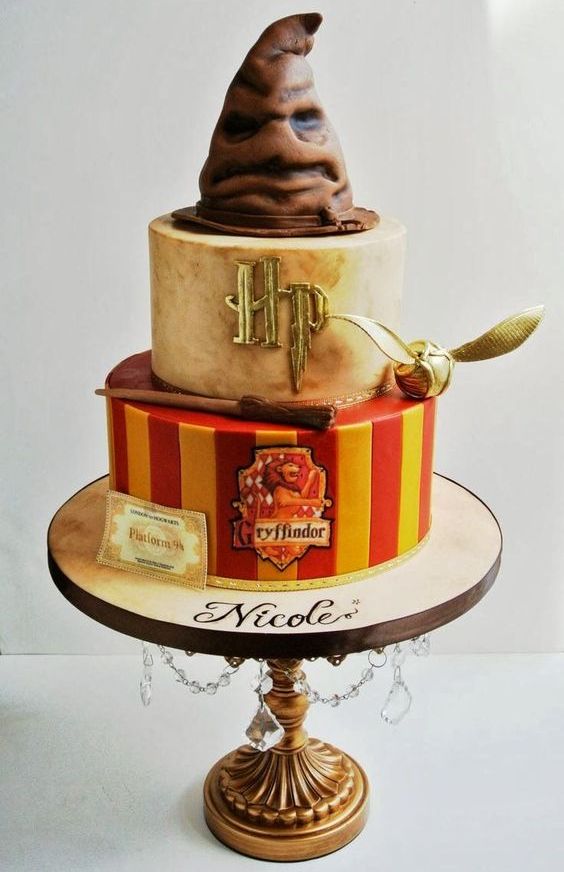 a gorgeous Harry Potter birthday cake topped with a hat and in Gryffindor colors