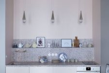 13 light pink cabinets and a grey spotted terrazzo backsplash